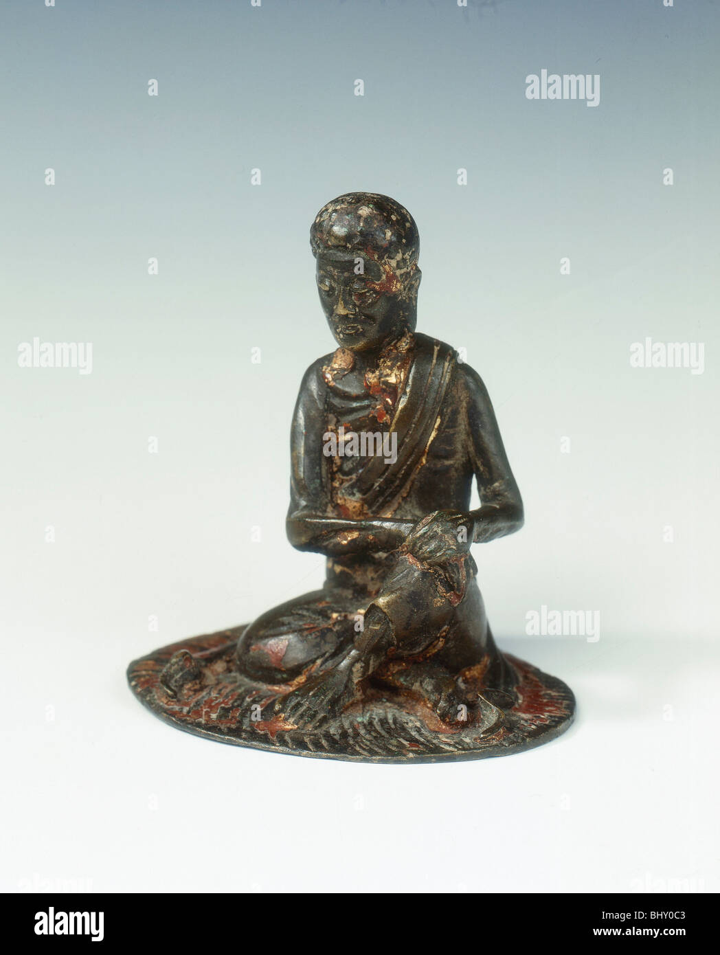 Gilt bronze statue of a lohan seated on a rush mat, late Ming dynasty, China, 1600-1644. Artist: Unknown Stock Photo