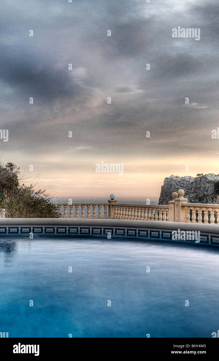 Beautiful Shot Over a Luxury Swimming Pool onto the Mediterranean Sea in Spain Stock Photo