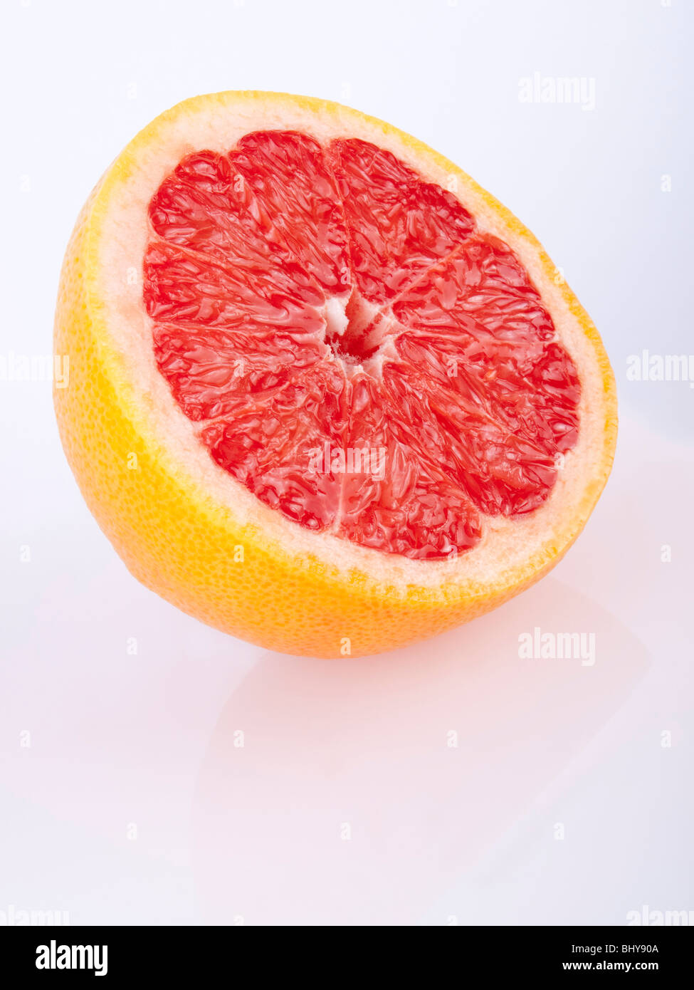 fresh juicy red grapefruit on white - reflection Stock Photo