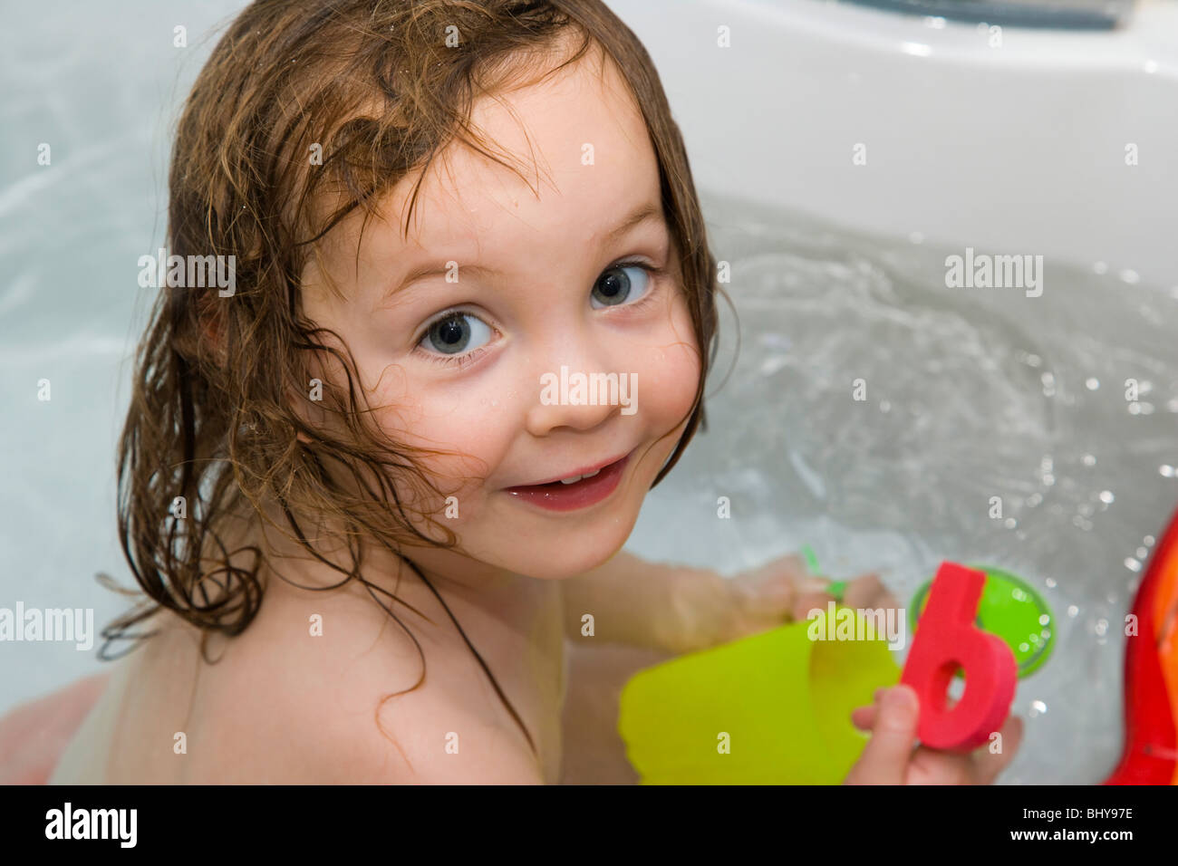 2 year old girl playing with toys in bath Stock Photo Alamy