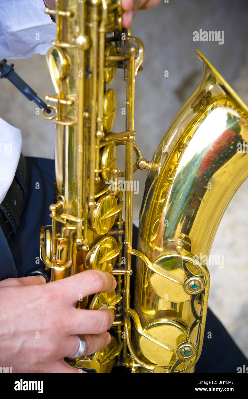 Saxophone player playing music Stock Photo - Alamy