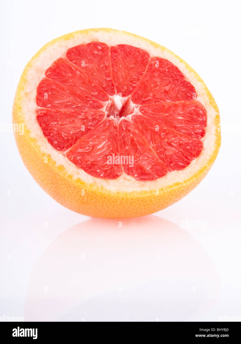 fresh juicy red grapefruit on white - reflection Stock Photo