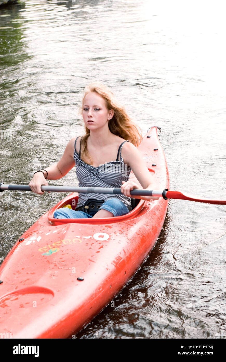 Young blond girl kayaking in nature on a summer day Stock Photo - Alamy