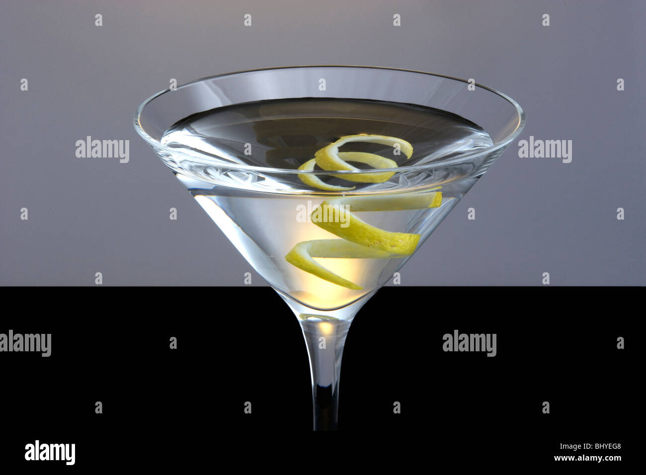 Straight up Martini with Lemon Twist Garnish on Black and Grey