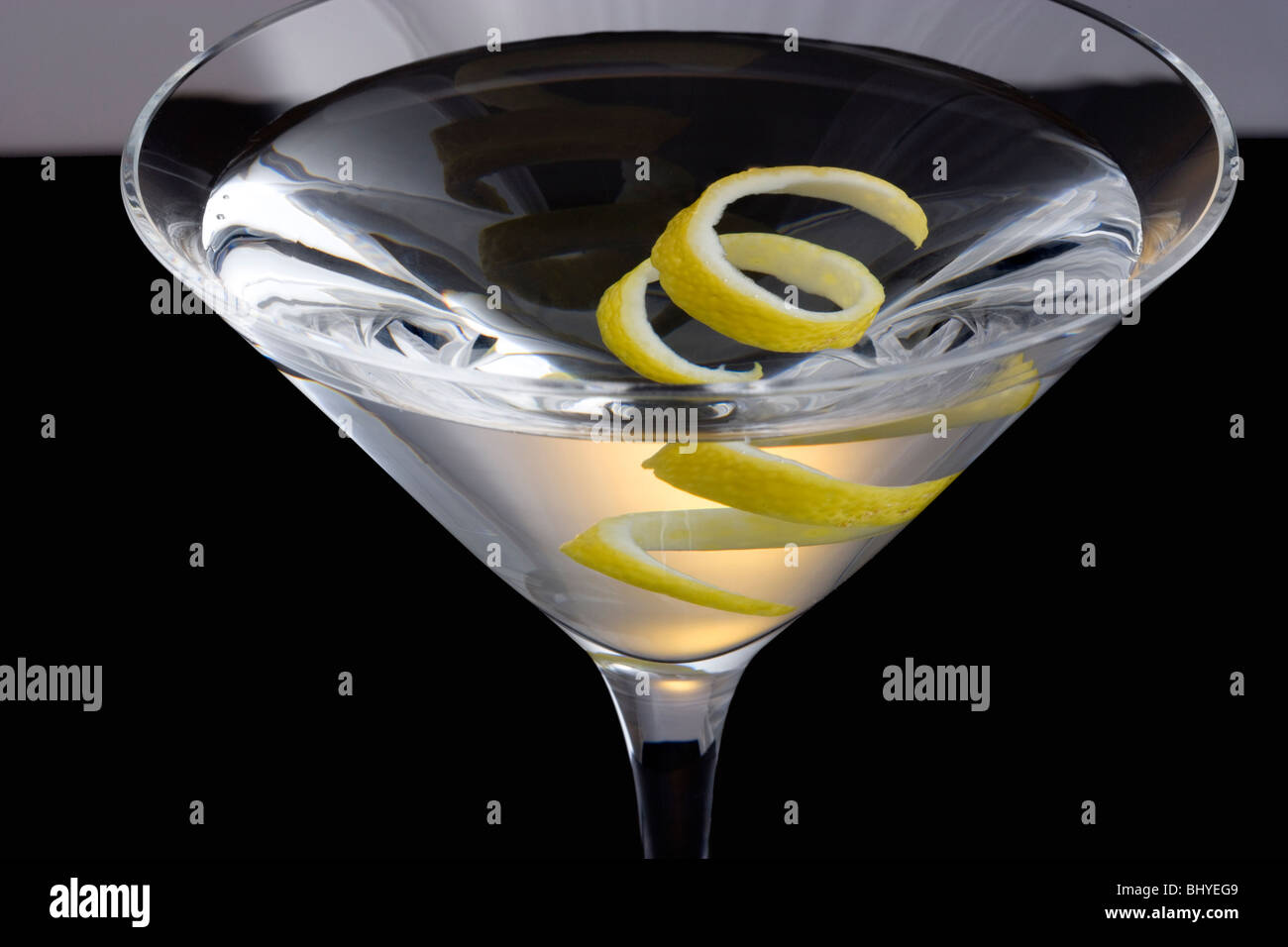 Straight up Martini with Lemon Twist Garnish on Black and Grey
