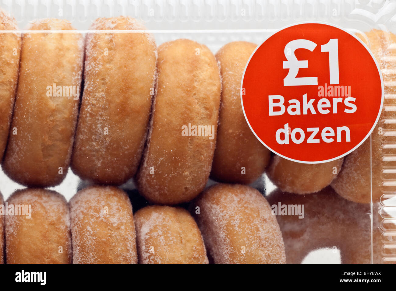 Bakers Dozen 13 donoughts in a plastic container Stock Photo