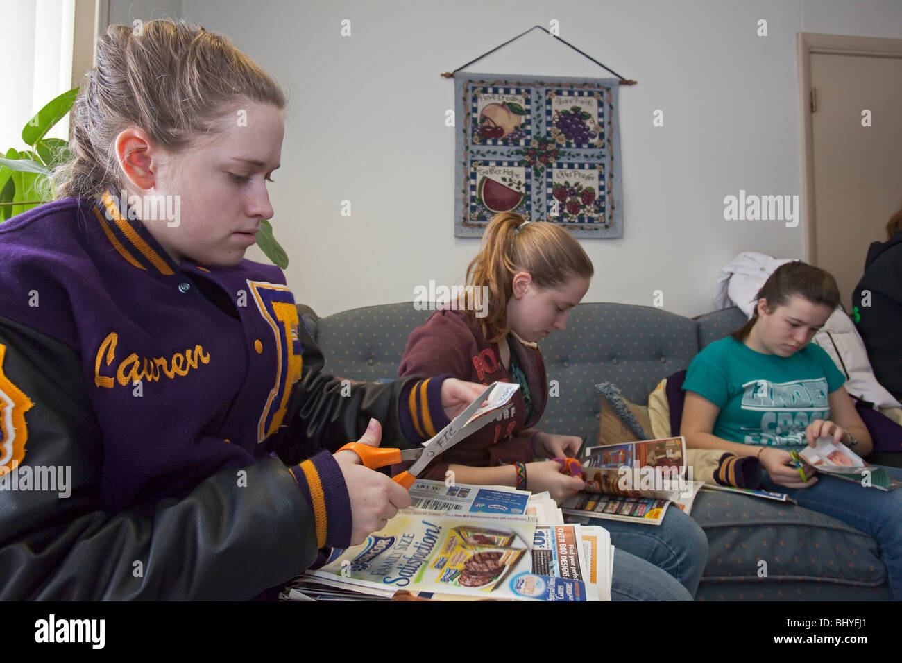 Teens Clip Coupons to Aid Food Purchases at Food Pantry Stock Photo