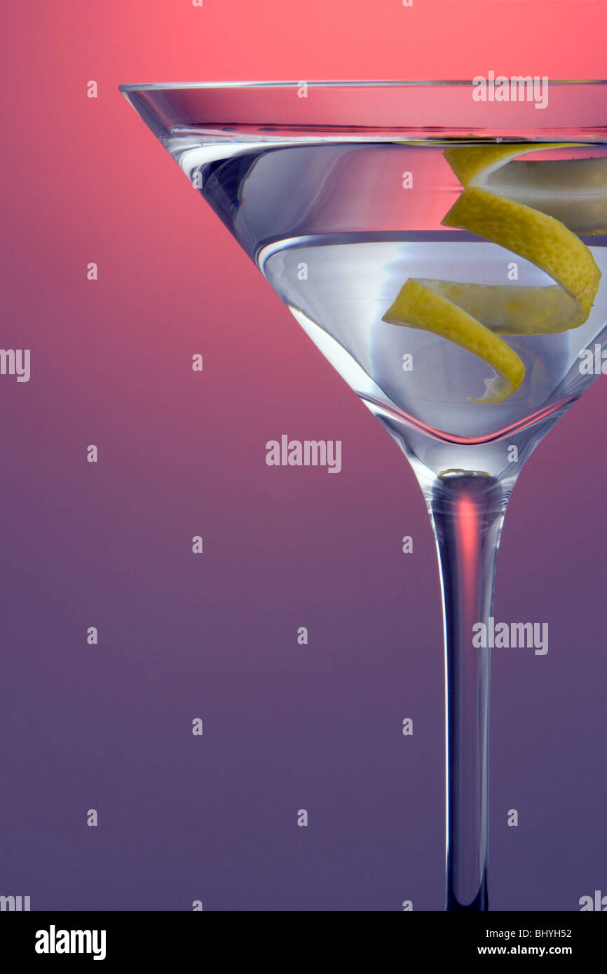 Spotlighted Straight up Martini with Lemon Twist Garnish on Colored background Stock Photo Alamy