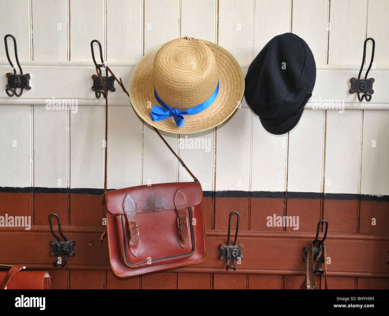Kingussie  folk museum - an old school cloakroom  with a  boater hat and soft school cap with leather school satchels. Stock Photo