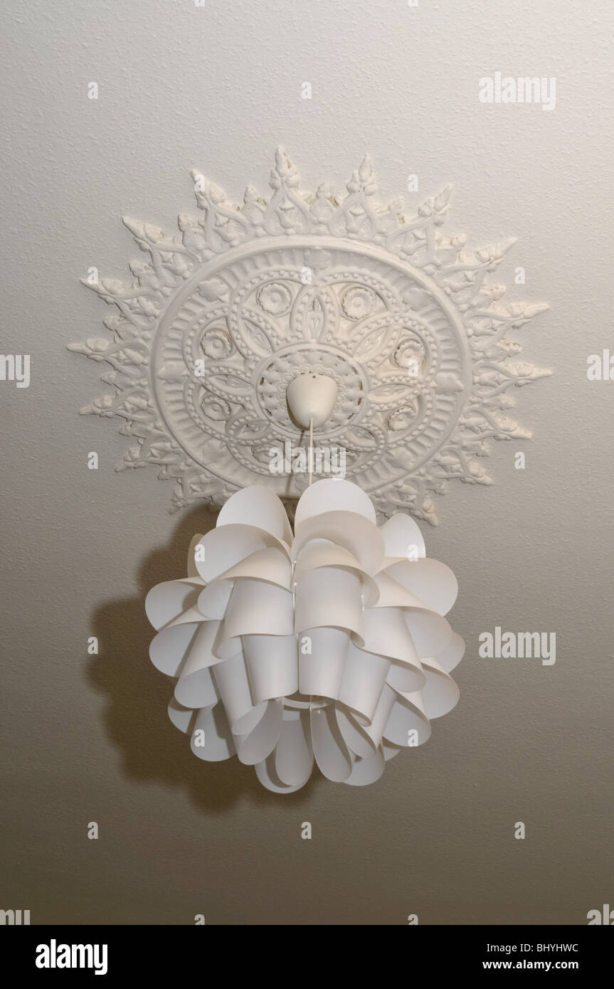 A ceiling rose and an elaborate ceiling light shade. Stock Photo