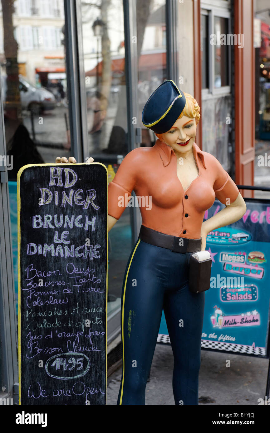 Mannequin of a busty diner waitress showing a menu in Paris Stock Photo