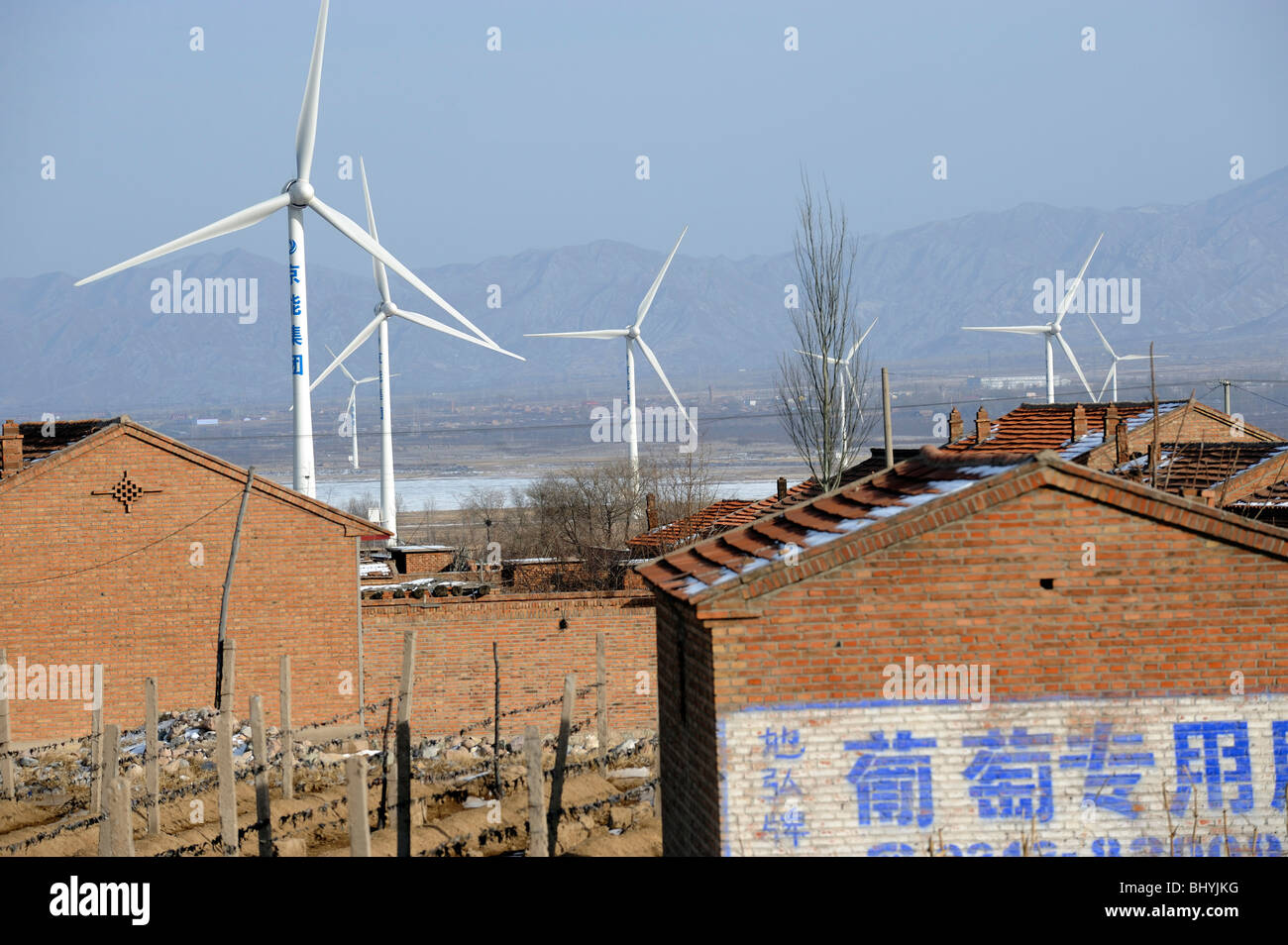 A village near Wind Farm in Huailai, Hebei, China. 02-Mar-2010 Stock Photo
