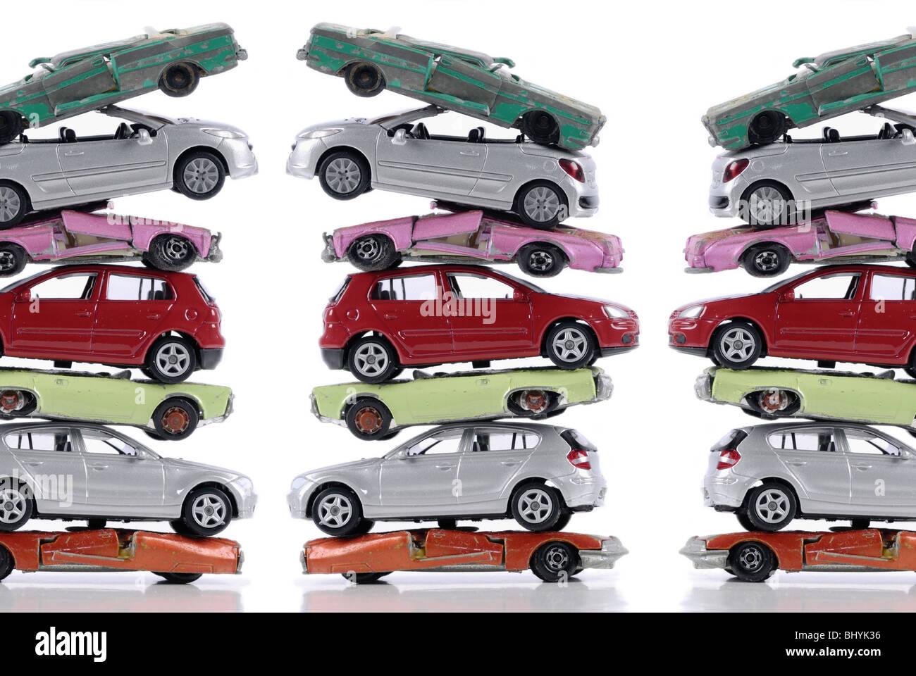Broken and new stacked miniature cars, stagnant new cars sale after the end of scrapping bonus Stock Photo