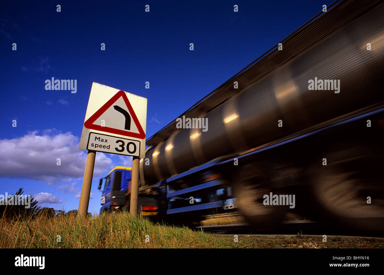 lorry passing warning sign of 30 mph speed limit and sharp left hand bend in the road ahead Ferrybridge yorkshire uk Stock Photo