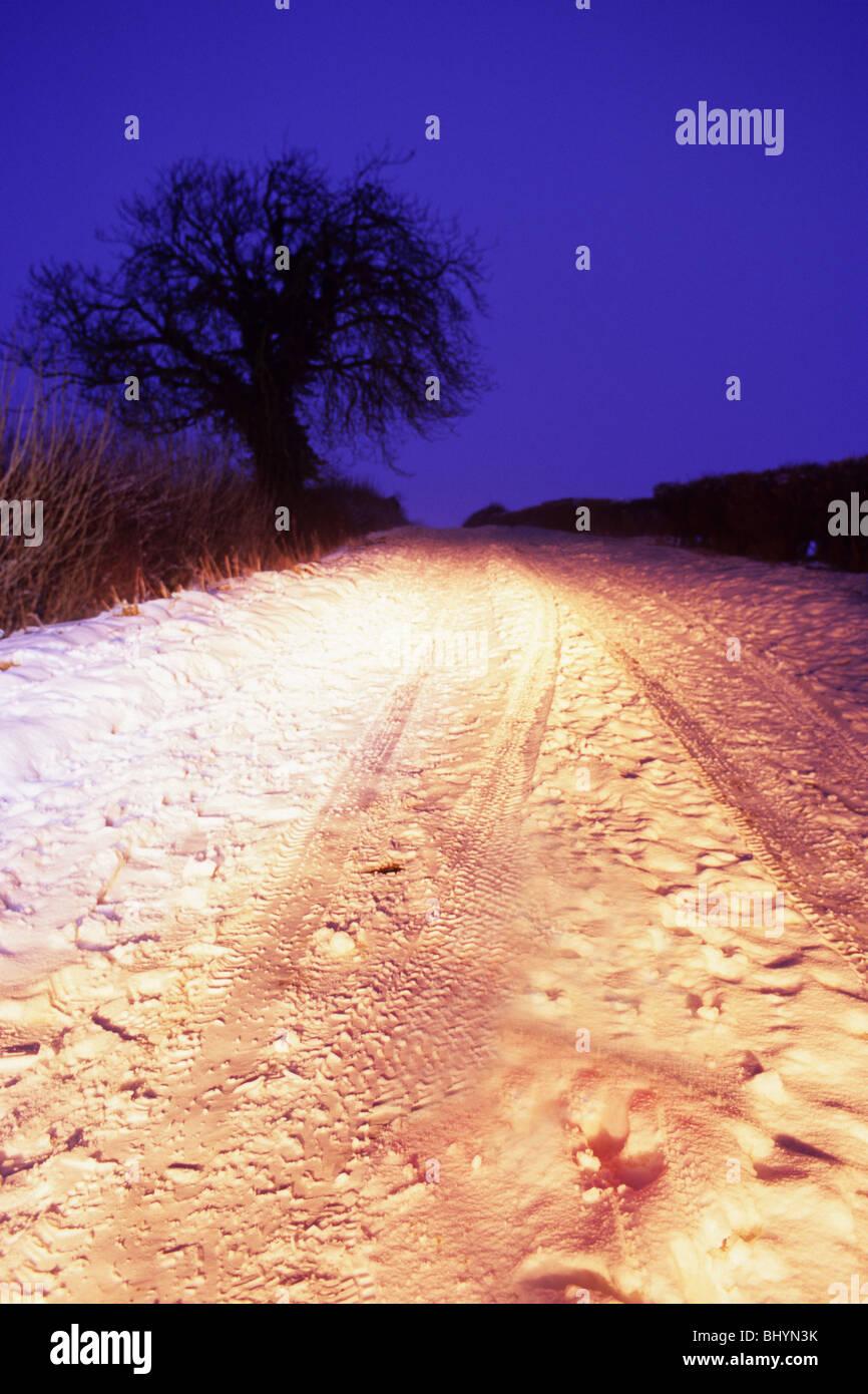 deep winter snow on country road at twilight near Leeds Yorkshire UK Stock Photo