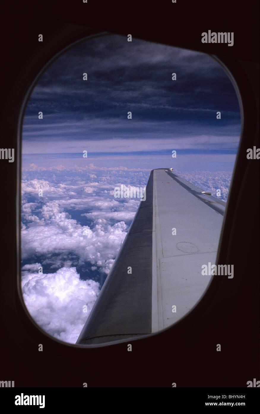 looking out of window at wing of Mc Donald Douglas 580 aeroplane in flight United States of America Stock Photo