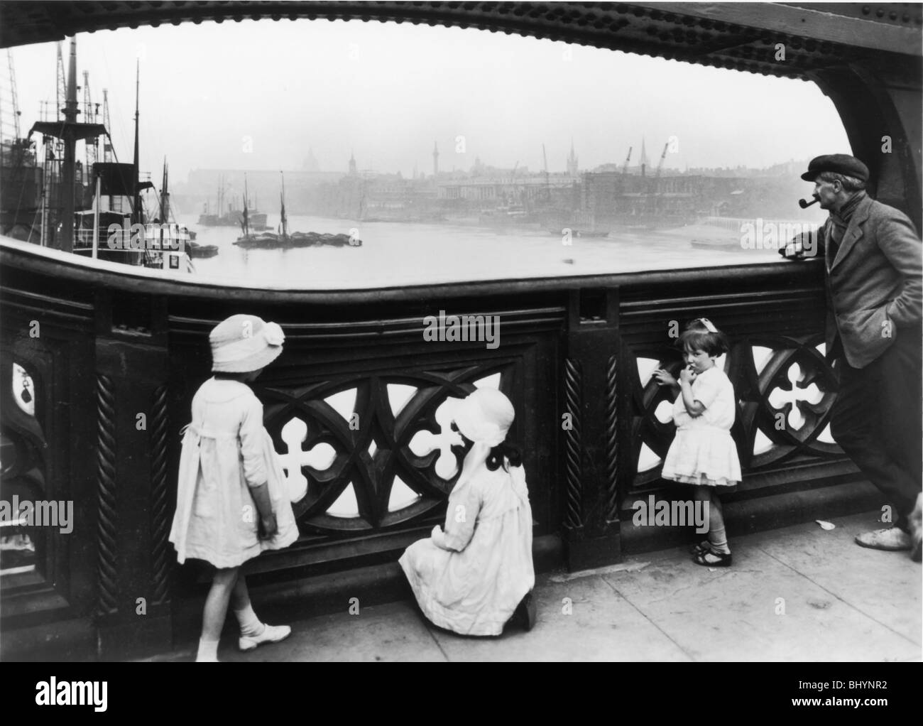 People watching the Thames from Tower Bridge, City of London, c1930. Artist: George Davison Reid Stock Photo