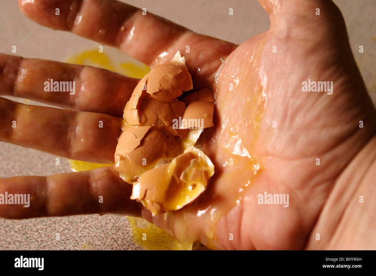 Crushed egg in a hand Stock Photo Alamy