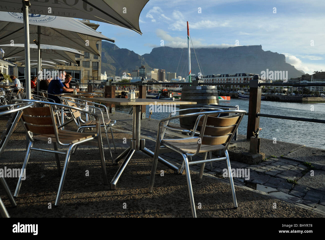 People sitting at cafe tables, Cape Town, South Africa, Victoria and Alfred waterfront at sunset