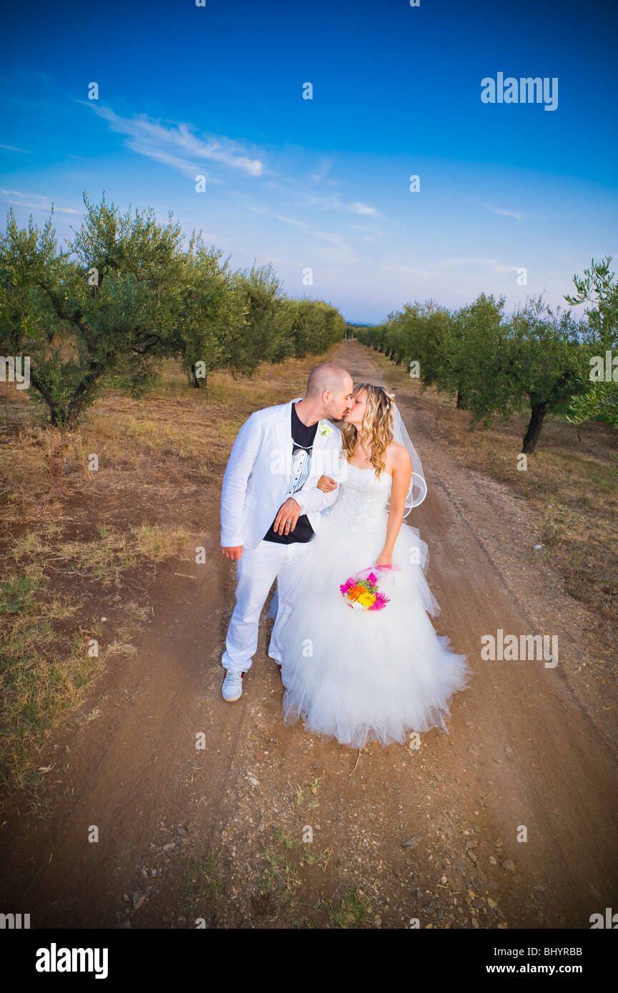 Bride and groom kissing on dirt road in vineyard Stock Photo - Alamy