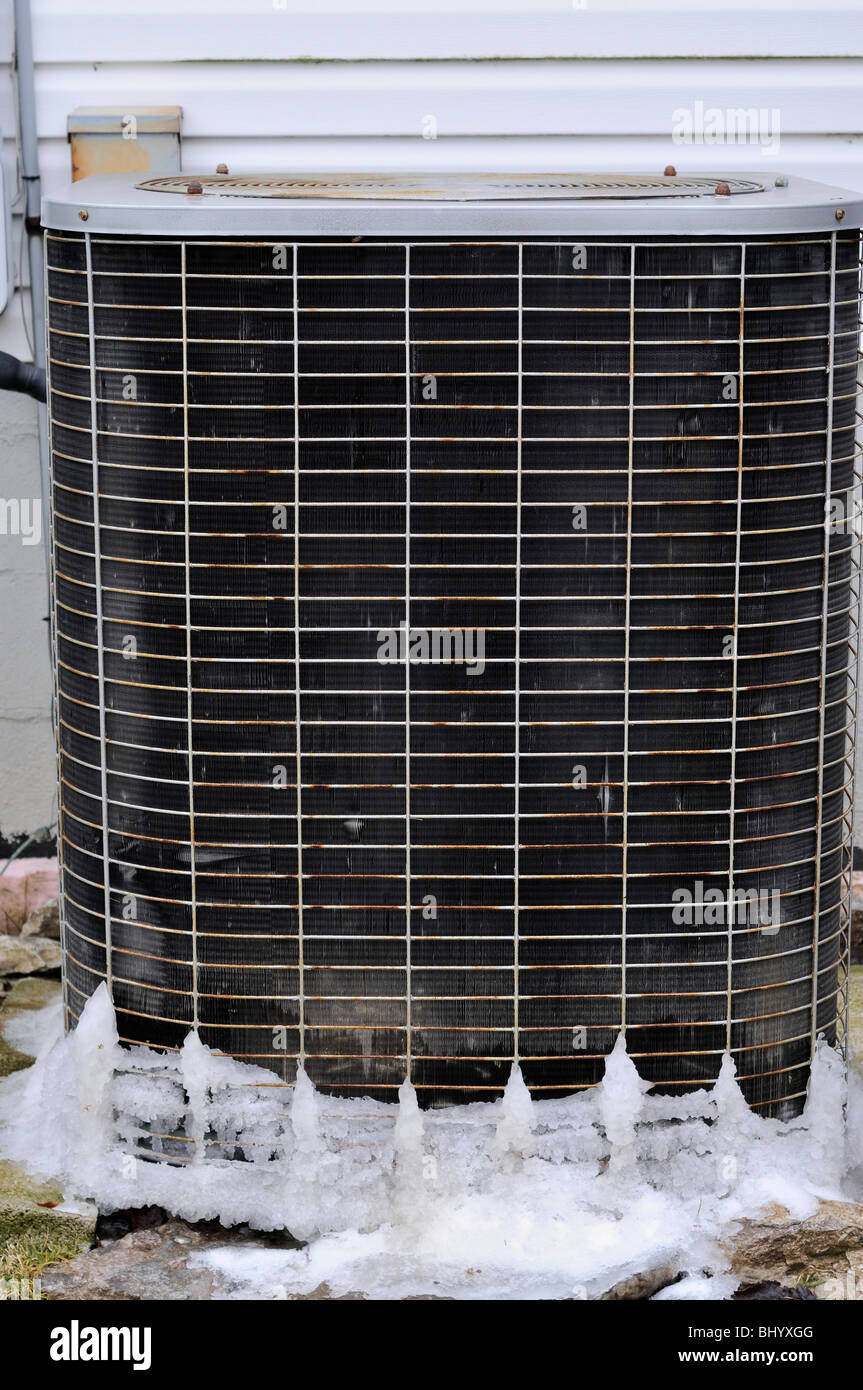 Heat pump unit with ice frozen on it in winter Stock Photo Alamy