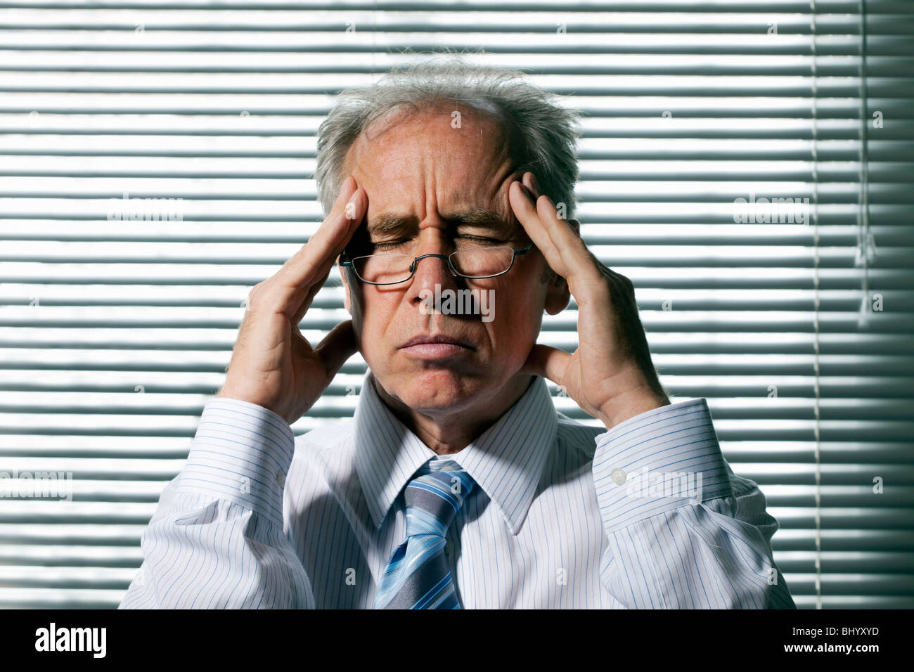 Middle aged man with a headache Stock Photo