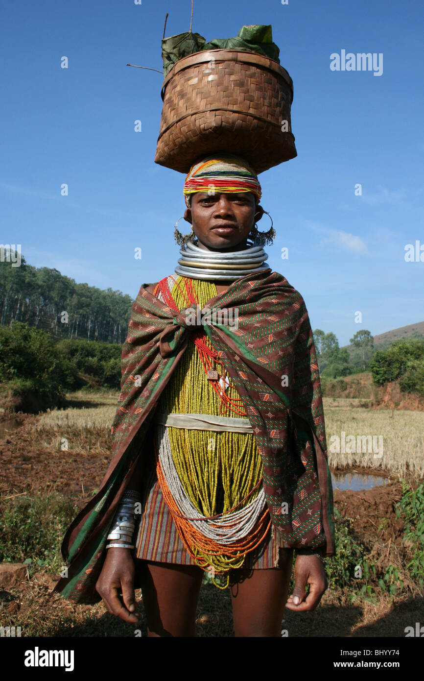Indian Bonda Tribe Woman Wearing Neck Rings Carrying Basket on Head Stock Photo