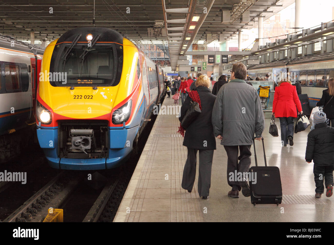 St Pancras railway station London passengers walk past an East Midlands Trains Class 222