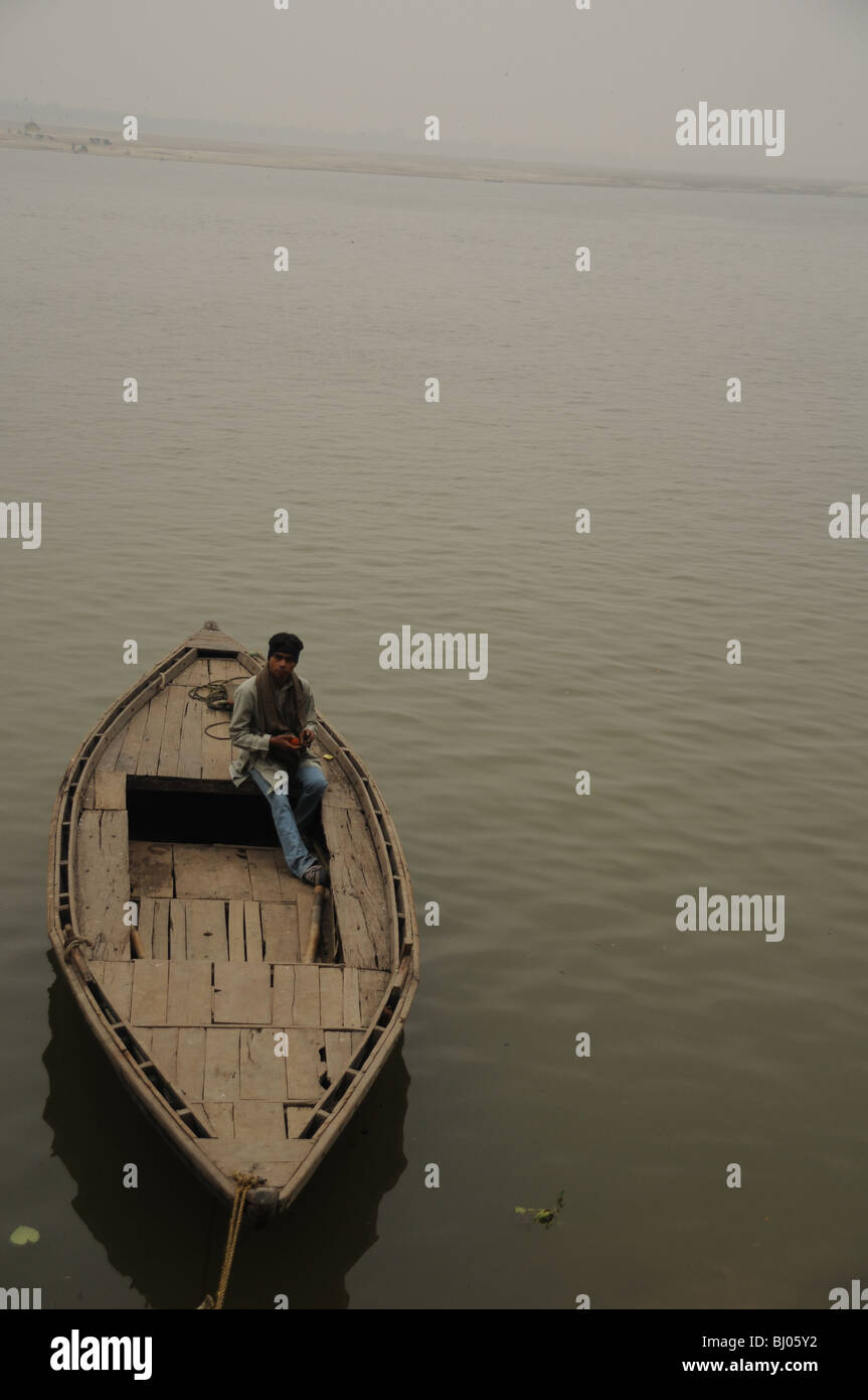 a man sitting in his boat relaxing and gathering his thoughts in the afternoon. shanti shanti Stock Photo