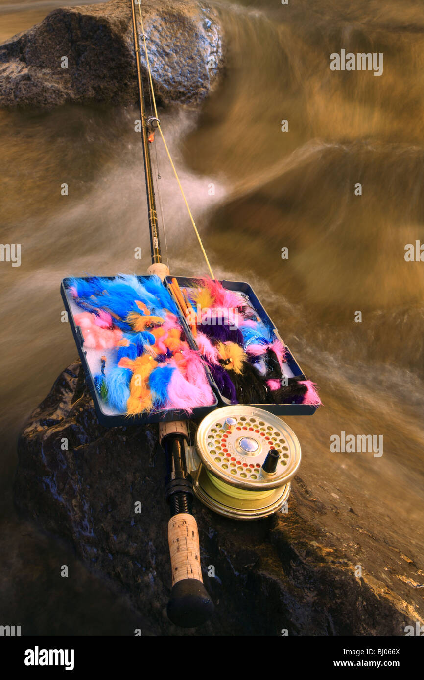 Fly rod and fly box on rocks in river, Bulkley river, Smithers, British