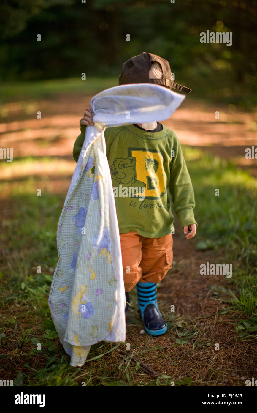 Young boy carrying blanket in hires stock photography and images Alamy