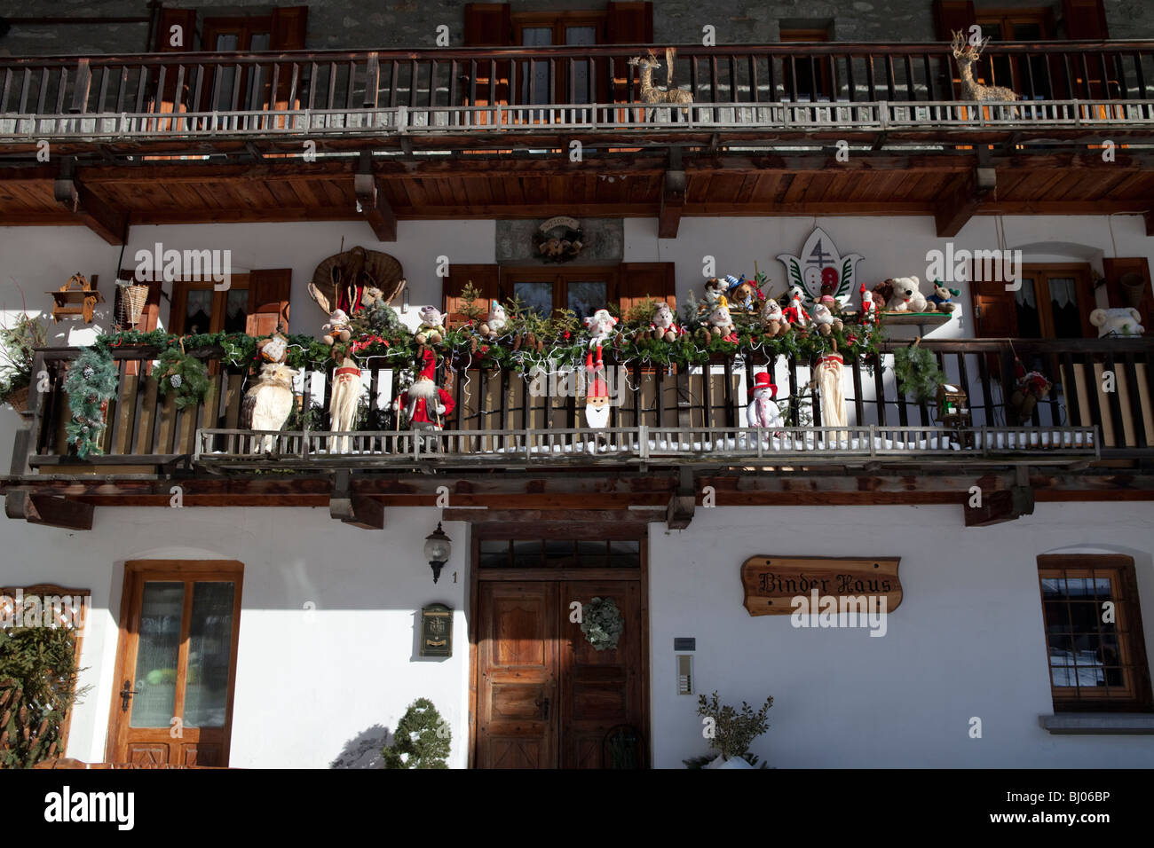 House with puppets and dwarfs on the balcony rail in antique village in the alps. Gressoney la Trinité, Valle d'Aosta, Italy Stock Photo