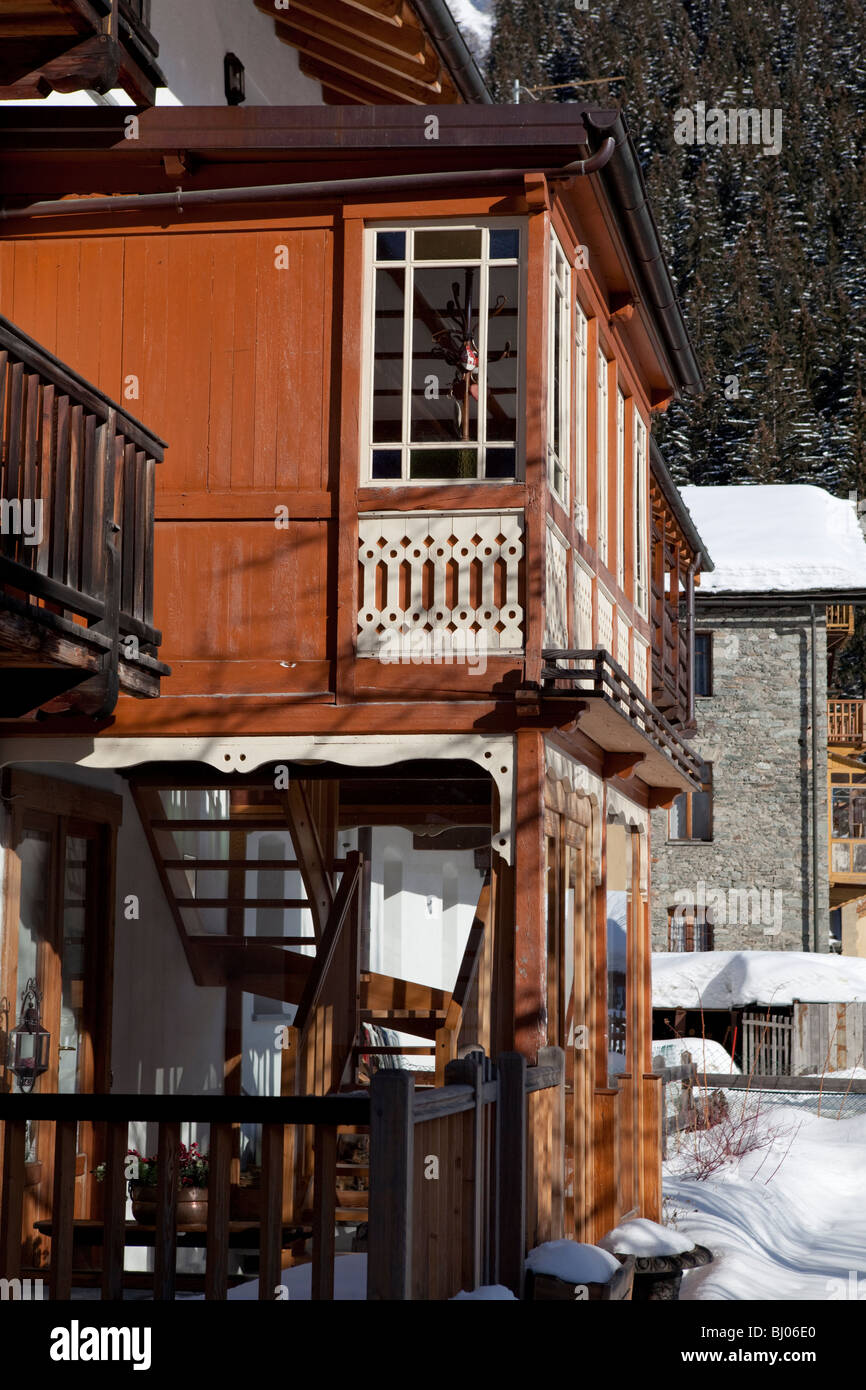 Enlarged house by using wood materials and glass. Gressoney la Trinité, Valle d'Aosta, Italy Stock Photo