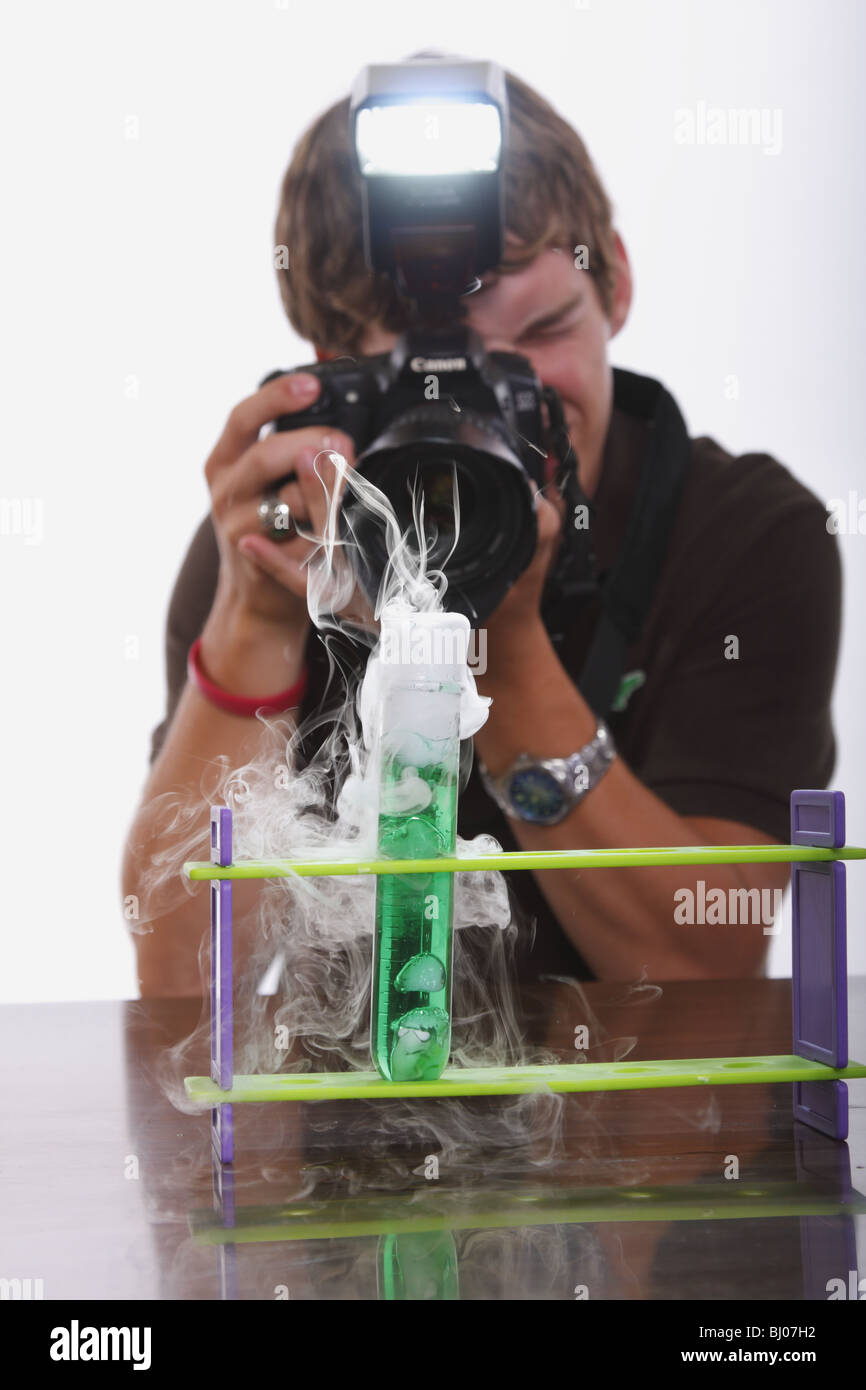 Student taking a picture of a test tube Stock Photo