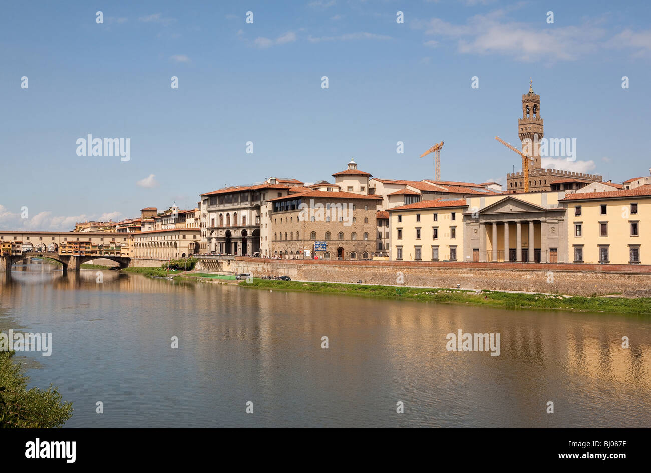 Sunny view over the River Arno in Florence in Tuscany Italy with Italys most famous medieval building the Palazzo Vecchio Stock Photo