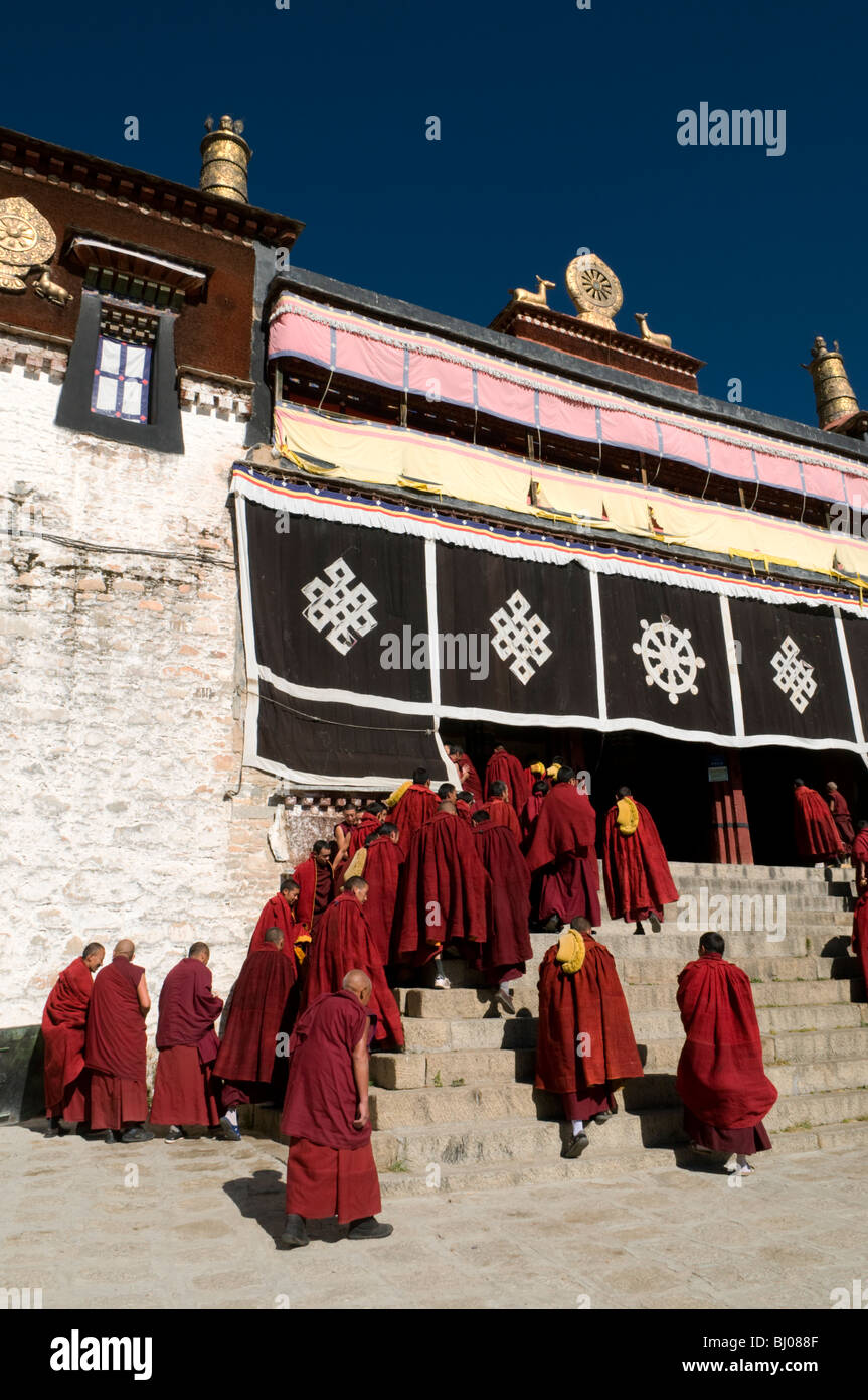 Monks in front of the main prayer hall at the famous Drepung Monastery, the largest in Lhasa Tibet. Stock Photo