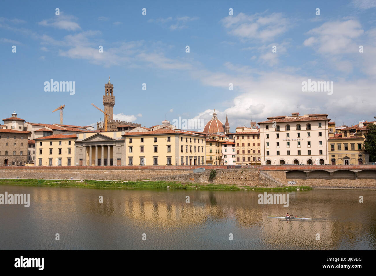 River Arno in Florence Italy with the famous medieval building the Palazzo Vecchio and Santa Maria del Fiore or Il Duomo Stock Photo