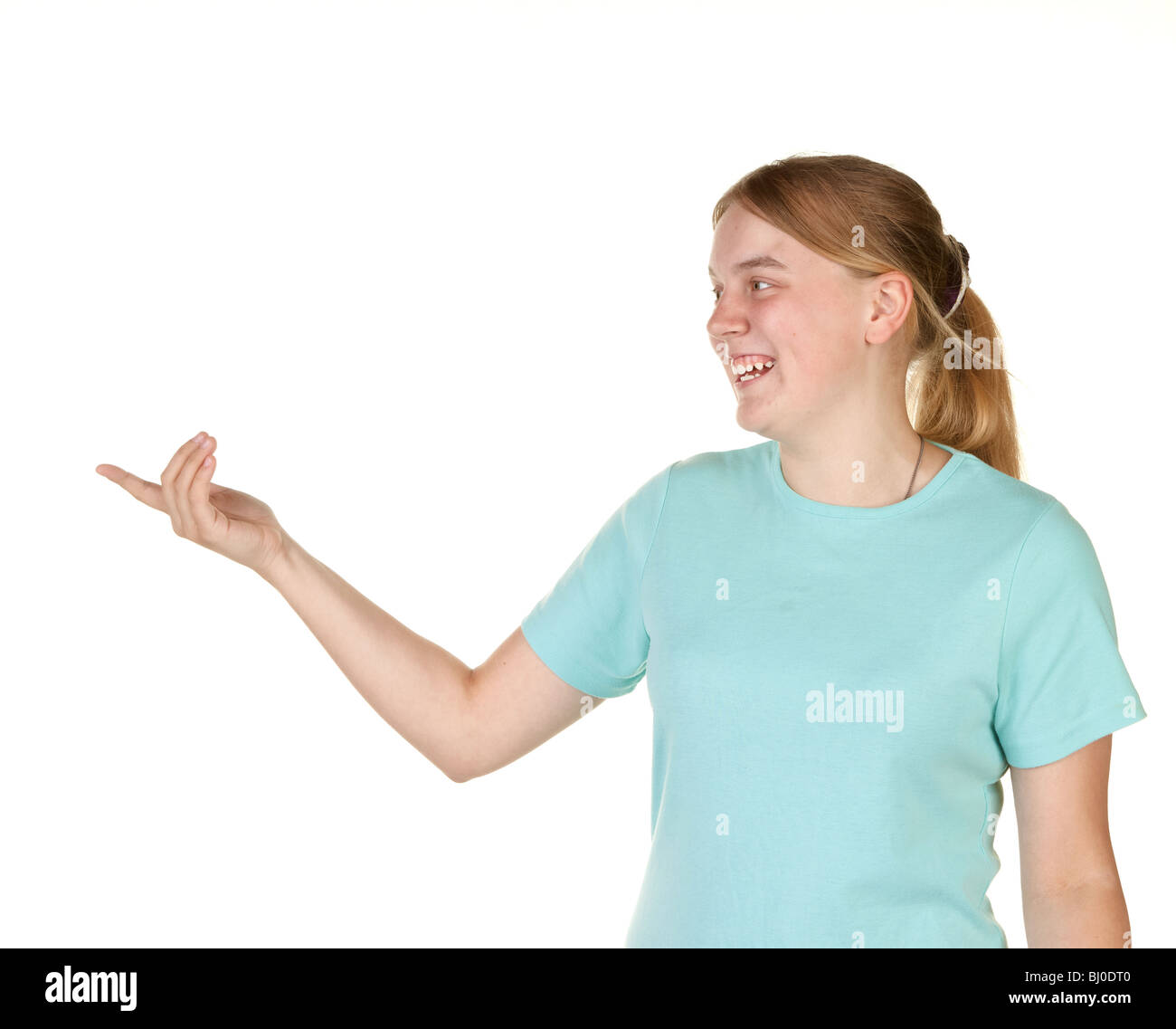 teenage girl gesturing and pointing to copyspace Stock Photo
