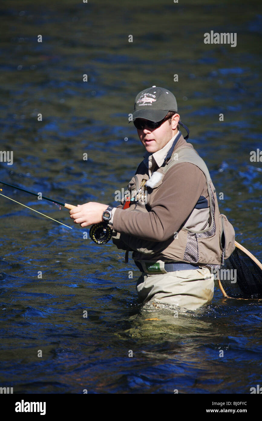FLY FISHERMAN FISHING IN FAST RUNNING RIVER IN SEARCH OF TROUT TOCCOA