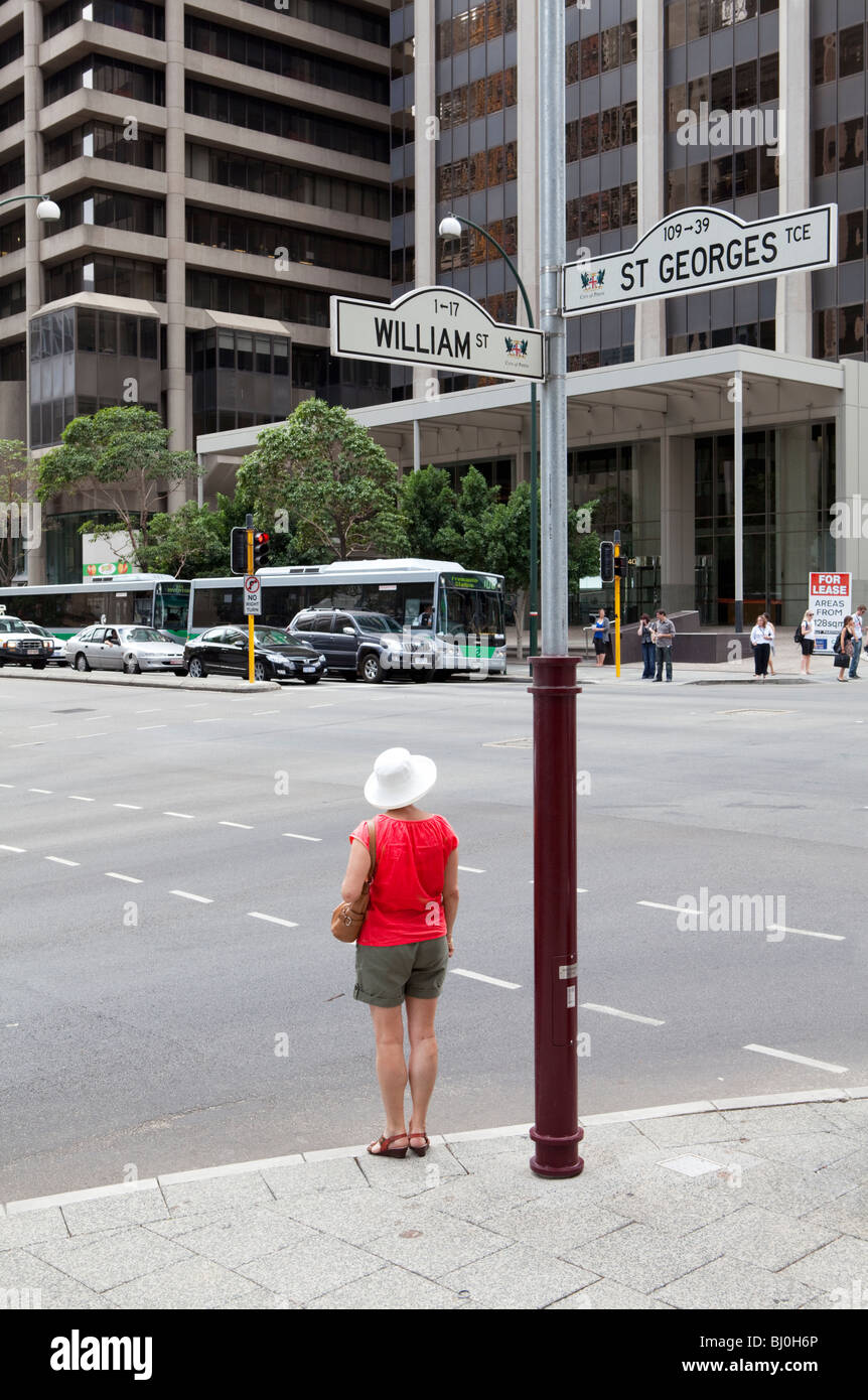 Woman waiting at crosswalk. Stock Photo