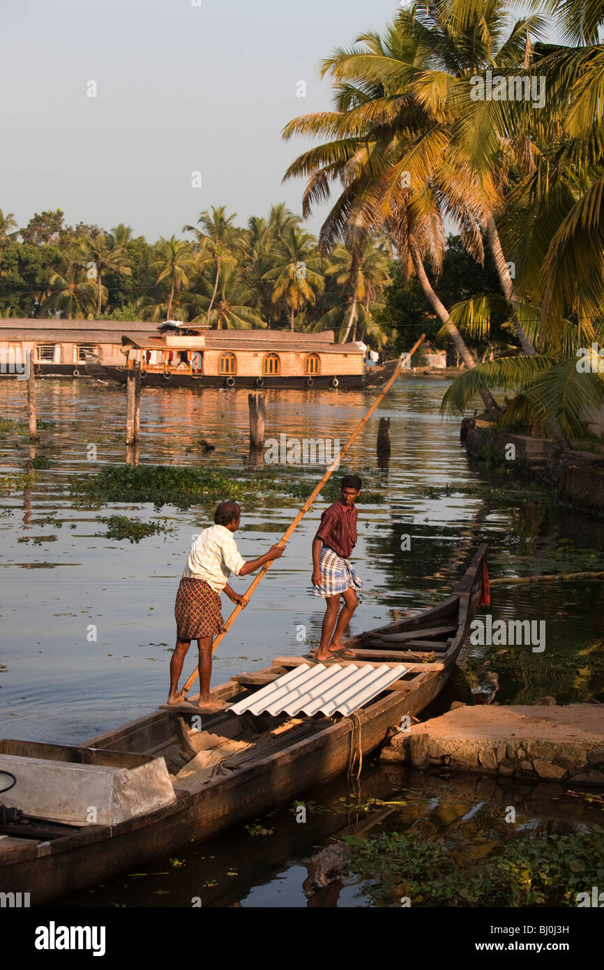 India, Kerala, Alappuzha, Chennamkary, backwaters, heavily laden dugout canoe carrying building materials Stock Photo