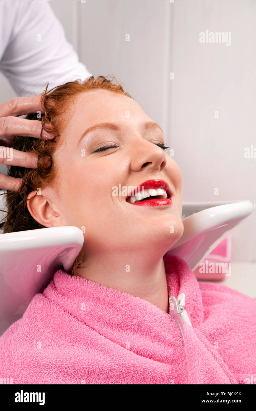 young woman at hair salon getting her hair washed Stock Photo