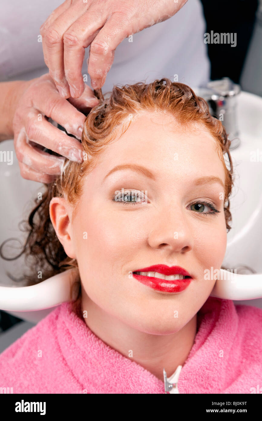 young woman at hair salon getting her hair washed Stock Photo