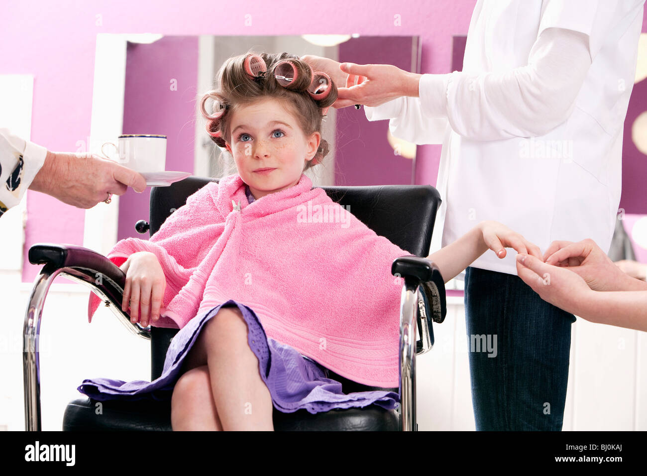 portrait of young girl at hair salon being served Stock Photo