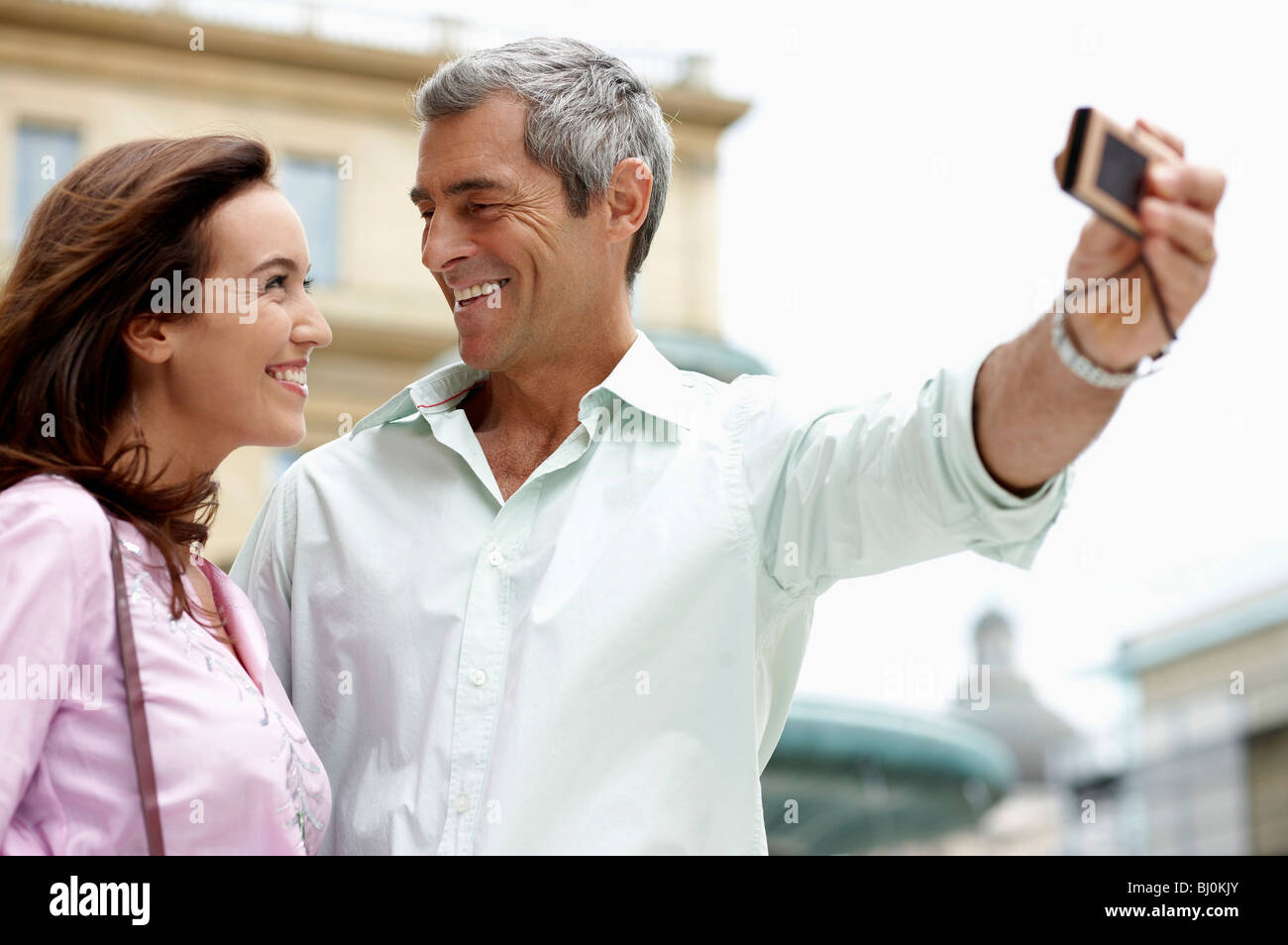 couple on vacation taking picture of themselves with digital camera Stock Photo