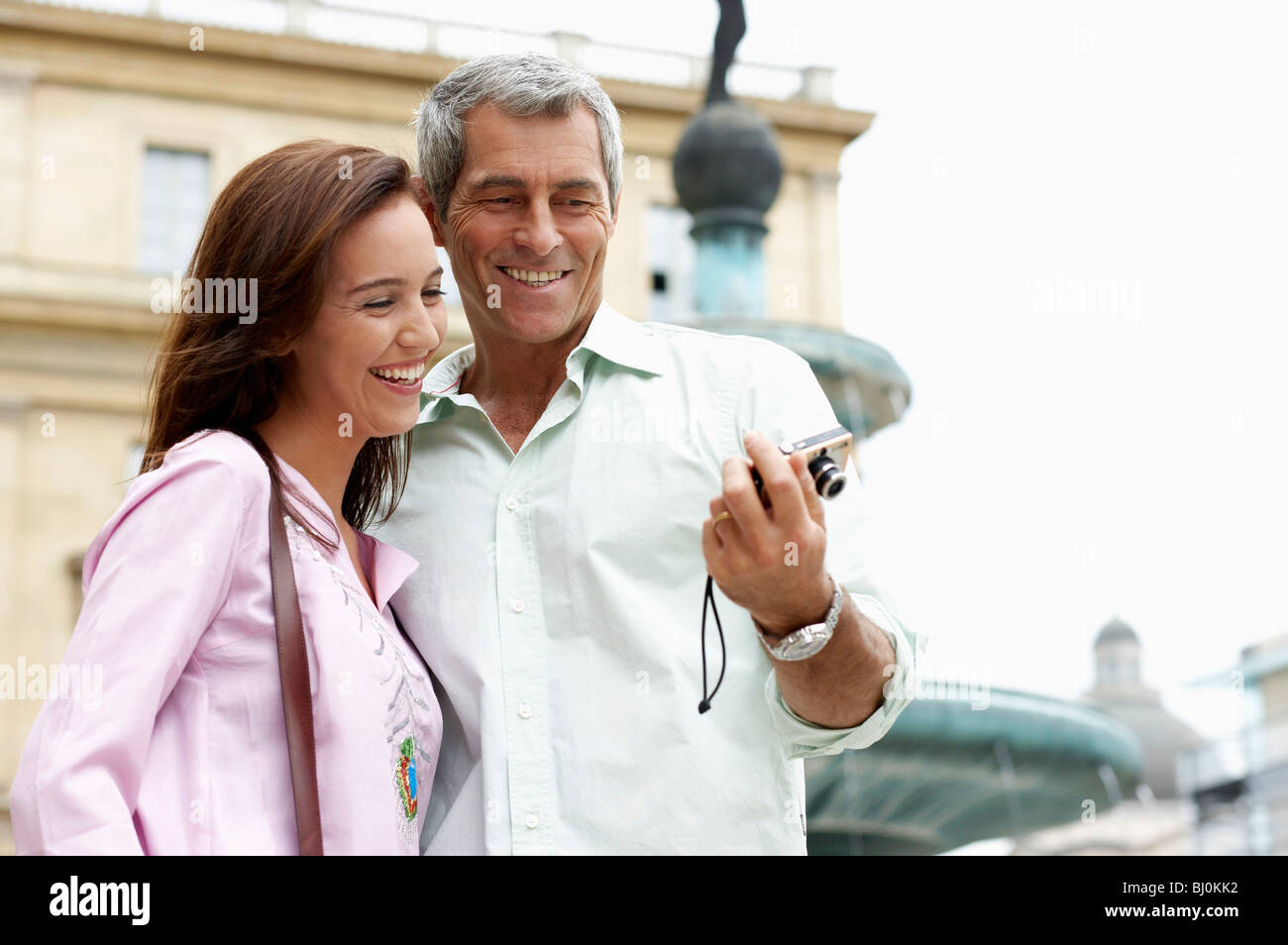 couple on vacation checking picture of themselves on digital camera Stock Photo
