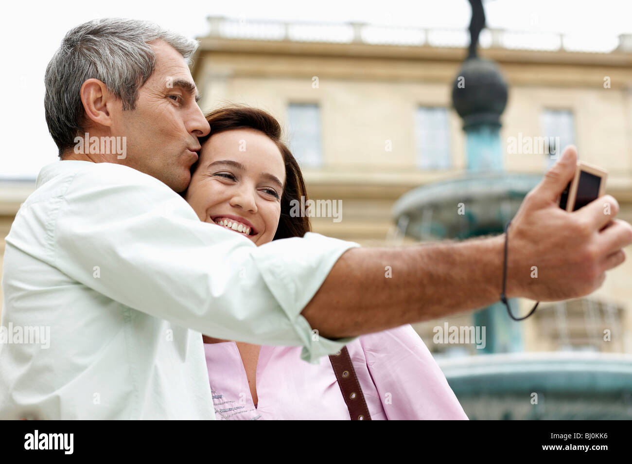 couple on vacation taking picture of themselves with digital camera Stock Photo