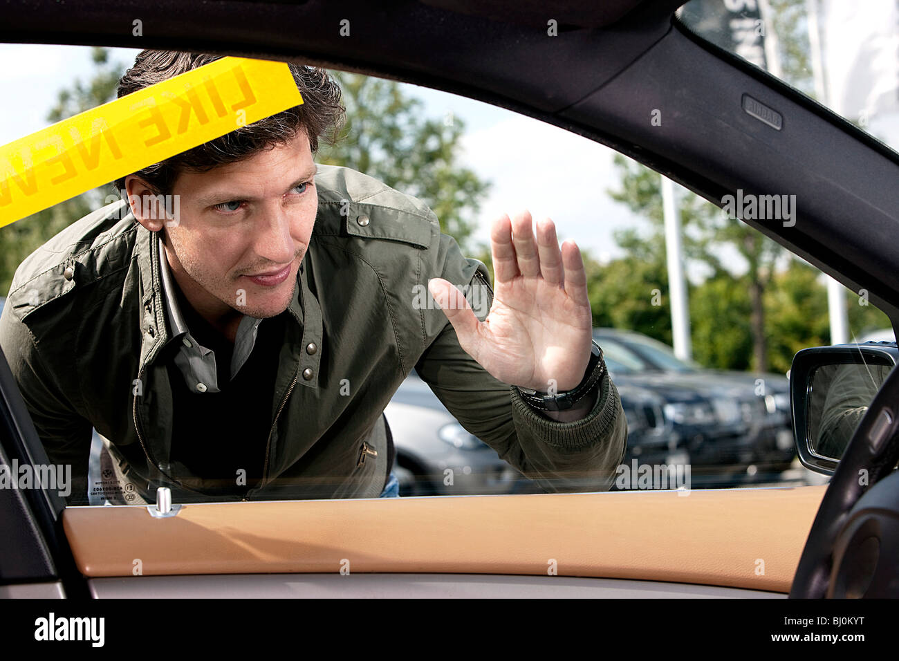 portrait of man looking through car window Stock Photo