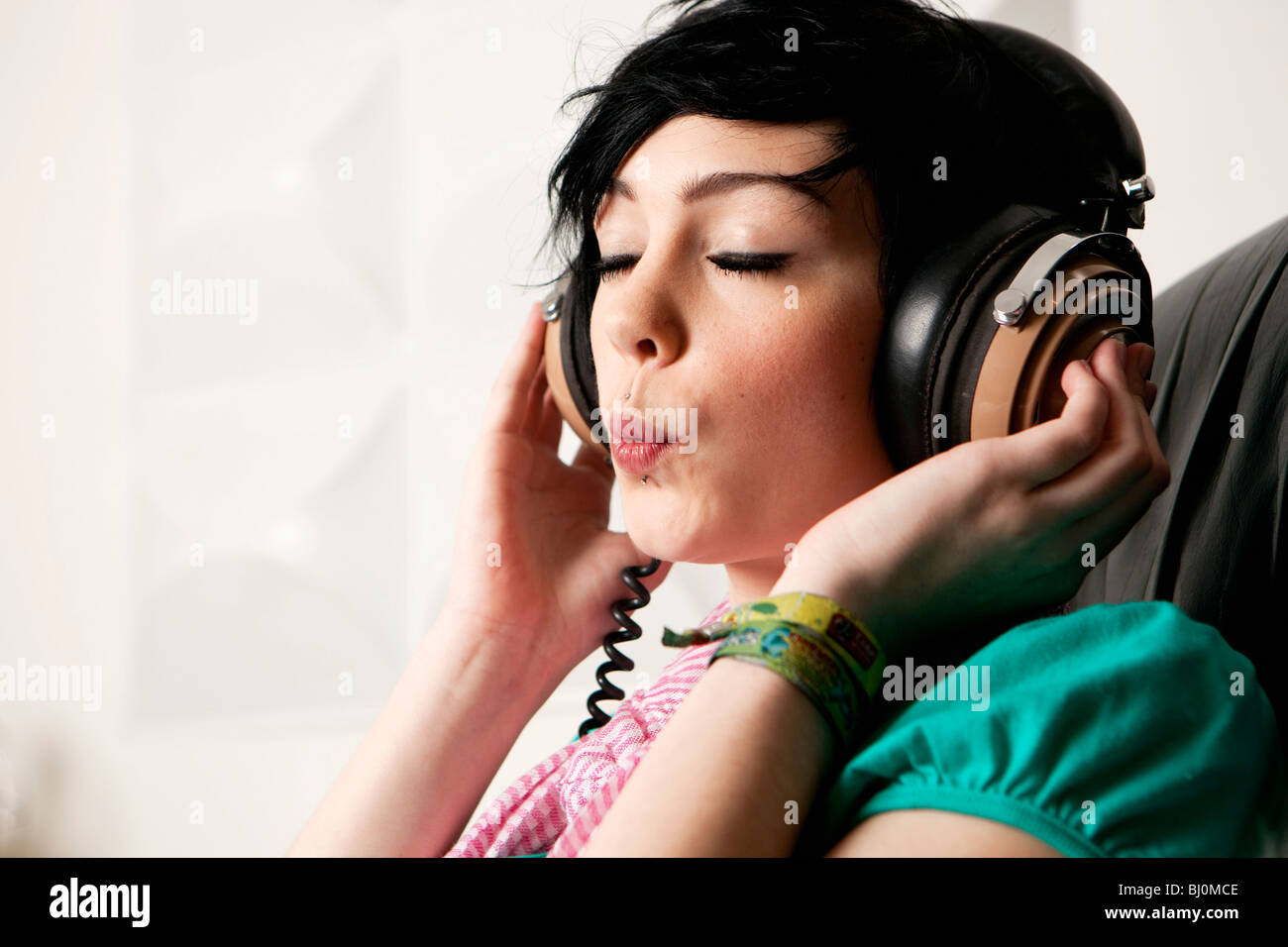 headshot of teenage girl listening to music Stock Photo