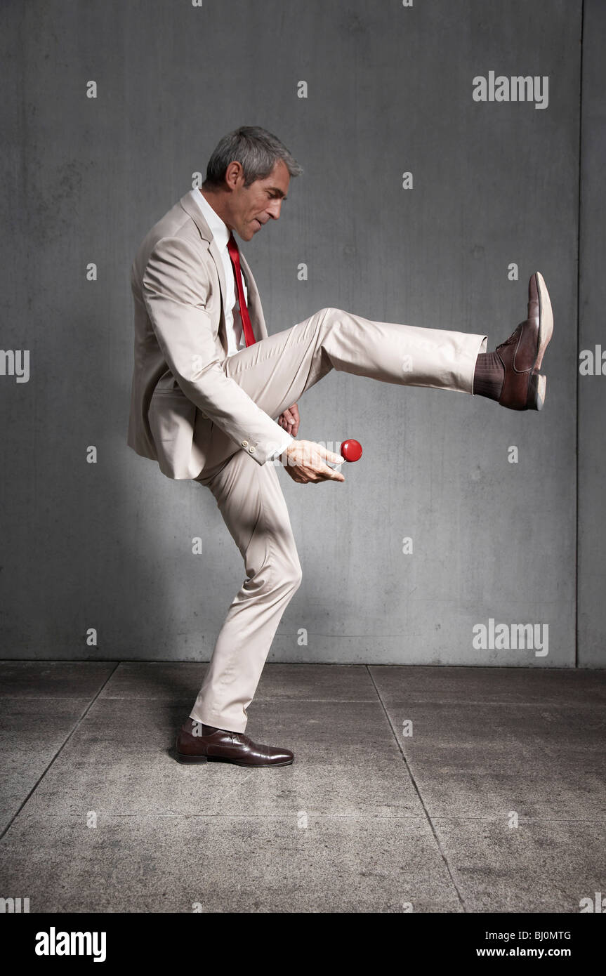 businessman playing with red yoyo Stock Photo